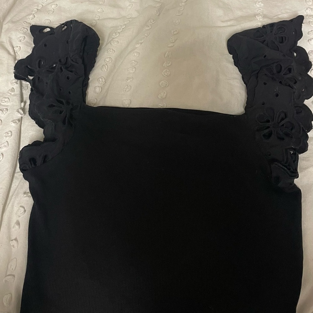 Cute summer themed black top with eyelet lace for sleeves!